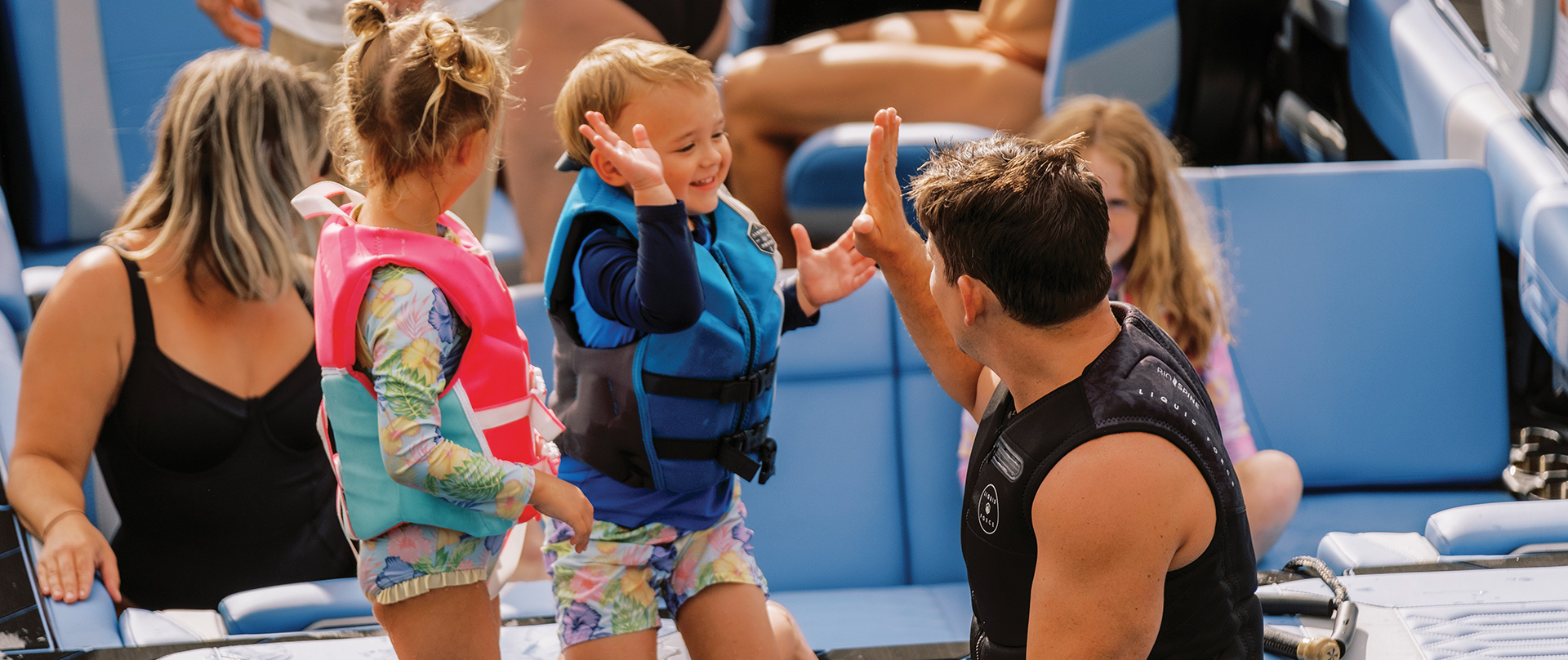 Hi fives on a Mastercraft Boat